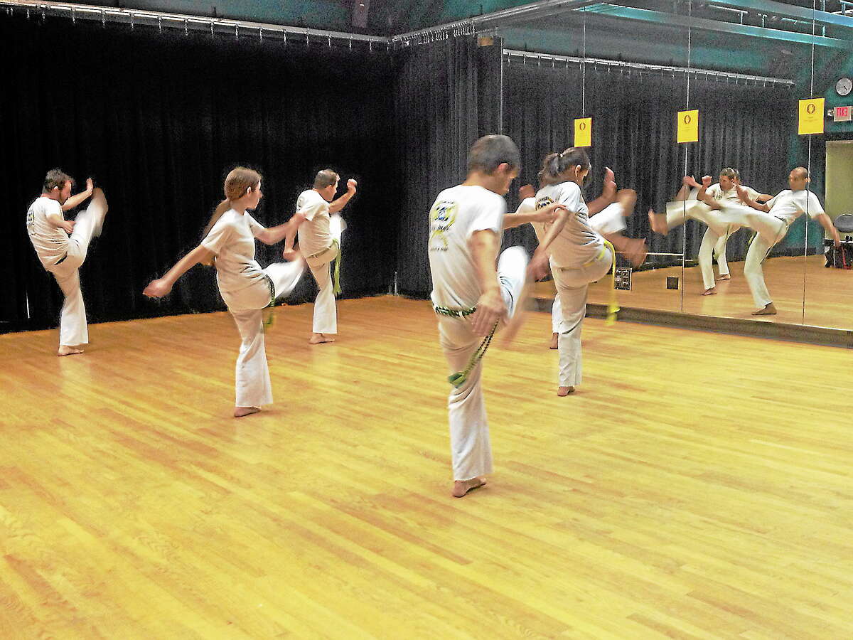 Capoeiristas rehearse moves at the Green Street Arts Center.