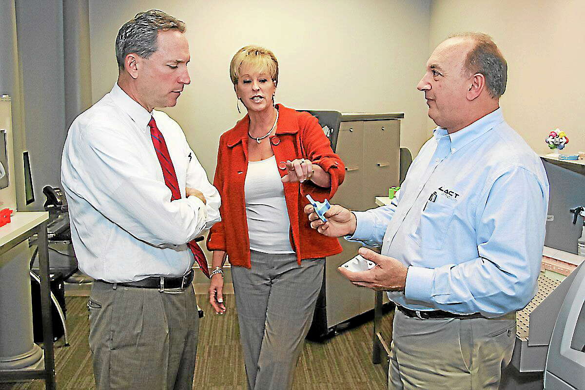 State Sen. Paul Doyle, left, listens to Cindi and Greg Gondek, owners of ACT Group in Cromwell, during a demonstration of the 3D printers they sell. The company is a beneficiary of Connecticut’s Small Business Express Program, which helped it build its 3D printer business and make new hires.