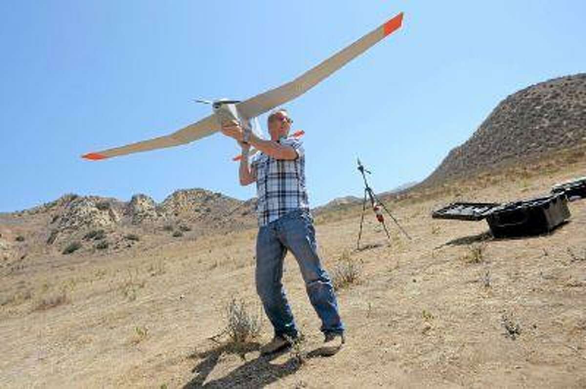 AeroVironment's Kris Waters prepares to launch an unmanned aircraft during a morning of testing in Simi Valley, CA. (Andy Holzman/Staff Photographer)