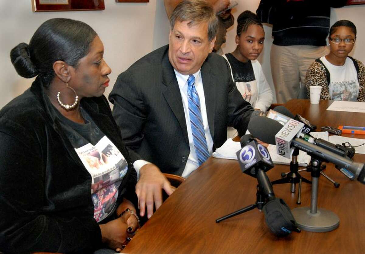 Attorney Richard Altschuler turns to comfort Olemae Hardy, left, mother of Chauncey Hardy, after he spoke some graphic details of her son's death. In back are Chauncey Hardy's sisters Jada Kinsey, left, 15, and Onnalise Hardy, 19. Altschuler held a press conference top discuss new details in the case. Melanie Stengel/Register