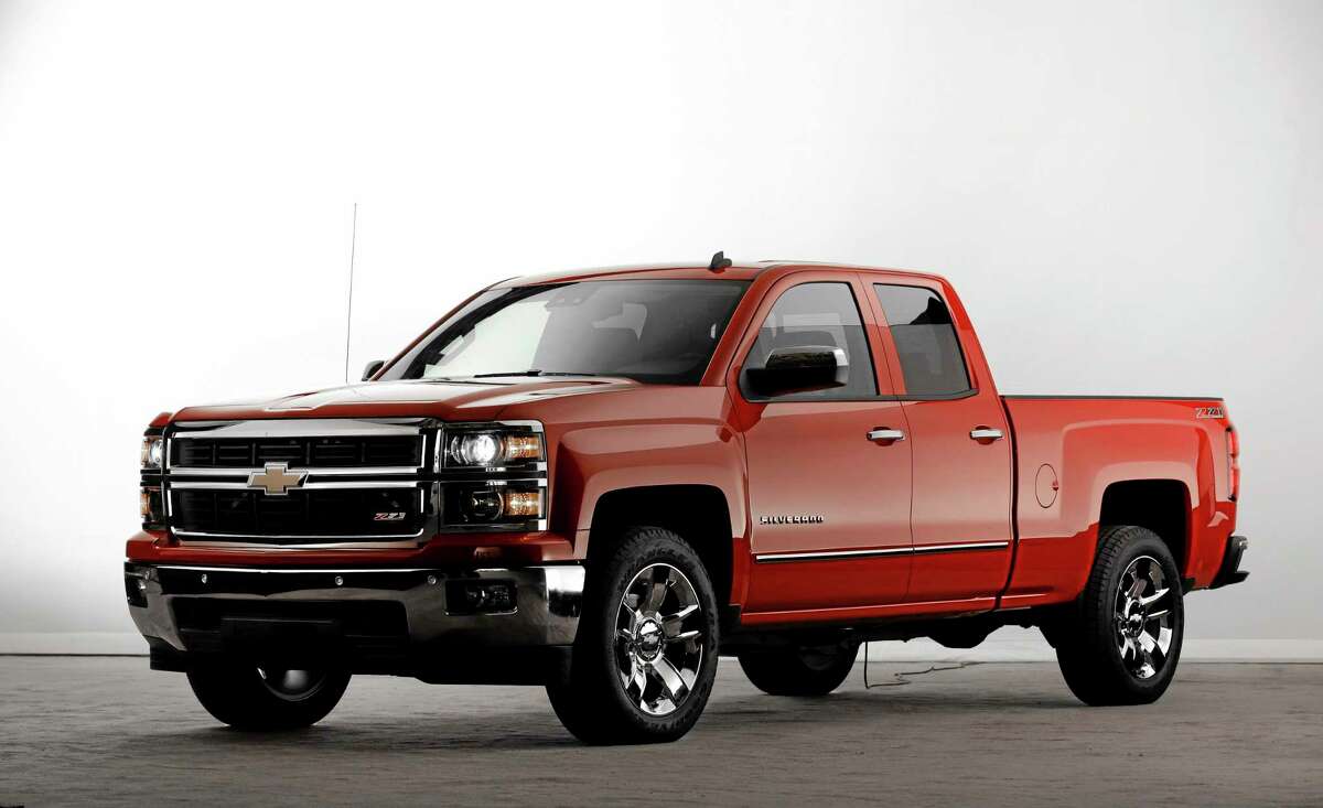 In this Dec. 13, 2012, file photo, the 2014 Chevrolet Silverado Z71 debuts in Pontiac, Mich. General Motors is adding almost $2,100 to the sticker price of the base 2014 Chevrolet Silverado. Despite a general rise in prices, the U.S government is expected to lose about $9.7 billion in bailout money on GM. (AP Photo/Paul Sancya, File)