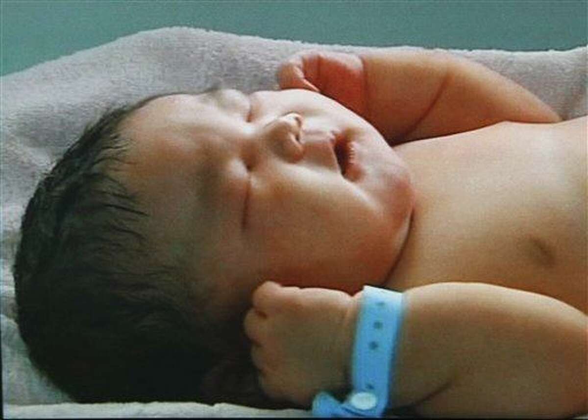 In this image made on Feb. 4 from CCTV television, a 15-pound baby named Chun Chun, sleeps at Xinxiang Maternity Hospital, in Xinxiang city, Henan province, China. Associated Press