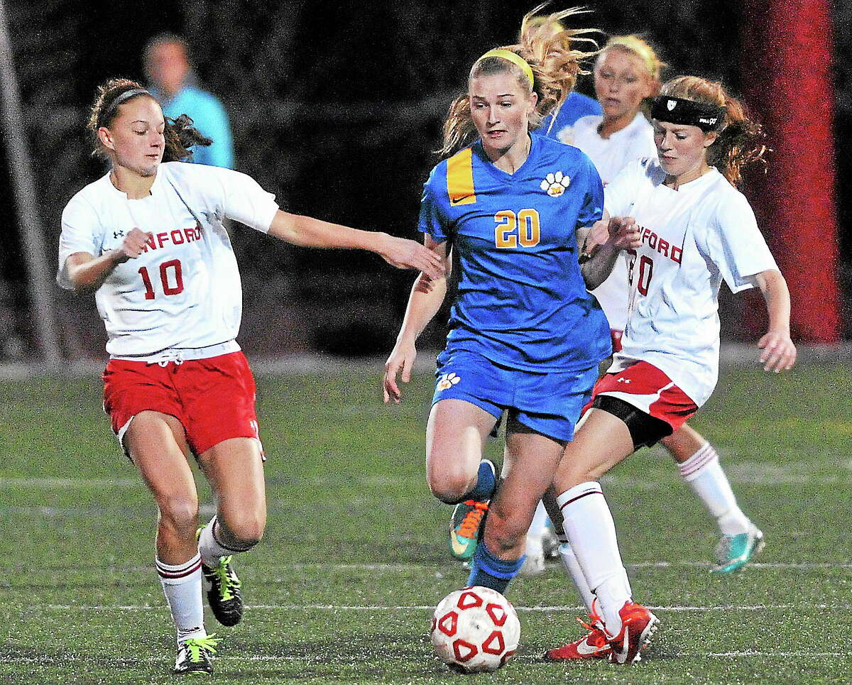 Mercy’s Kendra Landry drives between Branford’s Tanya Altrui, left and Cassidy McCarns during the first half.