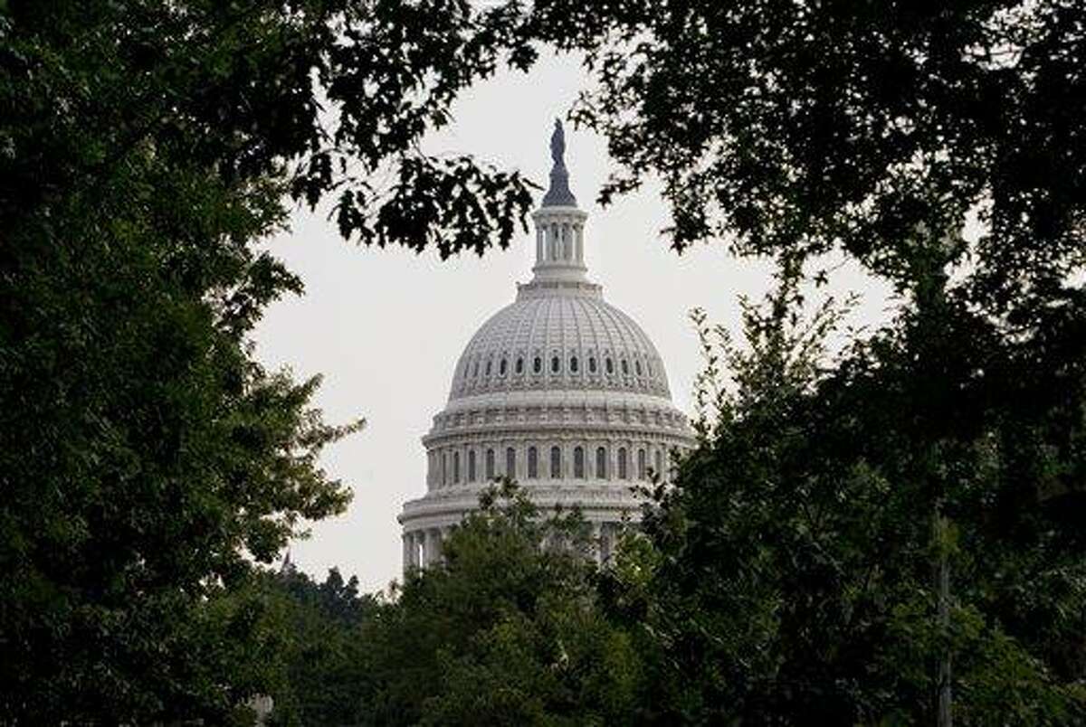 The dome of the Capitol is framed through dense summer foliage, in Washington, Tuesday, July 29, 2008. (AP Photo/J. Scott Applewhite)