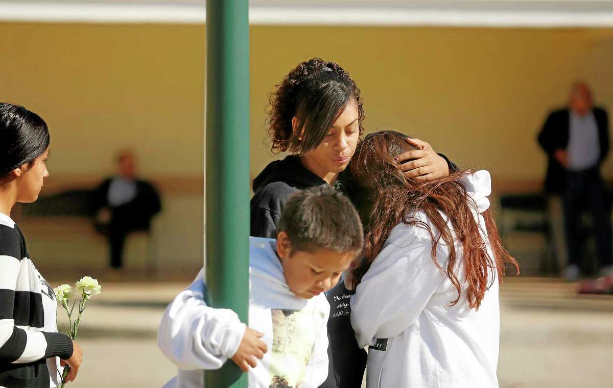 Mariah Burrham consoles her friend Aliyah Martinez during the memorial service and viewing of Andy Lopez at the Windsor-Healdsburg Mortuary on Sunday, Oct. 27, 2013. (AP Photo/The Press Democrat, Conner Jay)