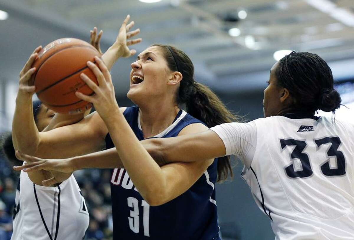 Connecticut's Stefanie Dolson (31) tries to shoot between Providence's Brianna Edwards (33) and Alexis Harris, left, in the first half of an NCAA college basketball game in Providence, R.I., Tuesday, Feb. 12, 2013. (AP Photo/Michael Dwyer)