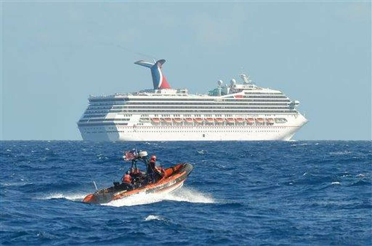 In this image released by the U.S. Coast Guard on Feb. 11, 2013, a small boat belonging to the Coast Guard Cutter Vigorous patrols near the cruise ship Carnival Triumph in the Gulf of Mexico, Feb. 11, 2013. The Carnival Triumph has been floating aimlessly about 150 miles off the Yucatan Peninsula since a fire erupted in the aft engine room early Sunday, knocking out the ship's propulsion system. No one was injured and the fire was extinguished. (AP Photo/U.S. Coast Guard- Lt. Cmdr. Paul McConnell