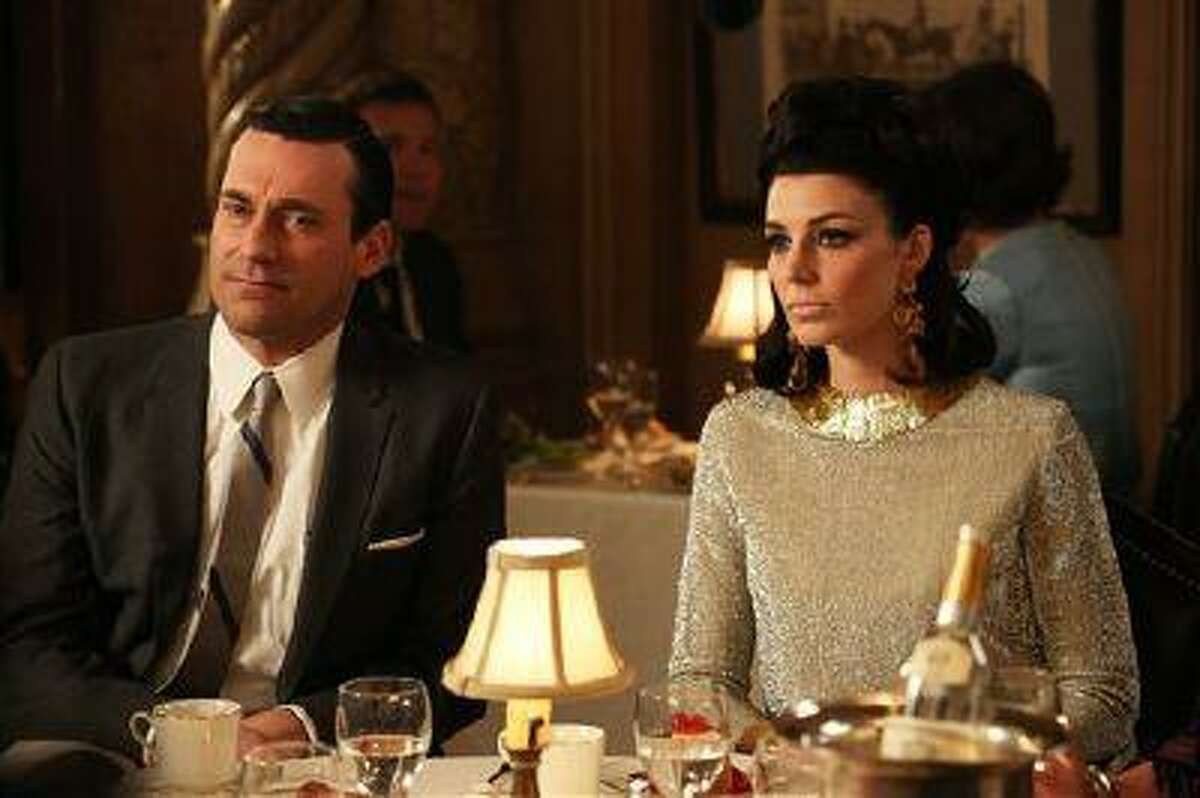This TV publicity image released by AMC shows Jon Hamm as Don Draper, left, and Jessica Pare as Megan Draper in a scene from "Mad Men." The season finale airs Sunday, June 23, on AMC. (AP Photo/AMC, Michael Yarish)