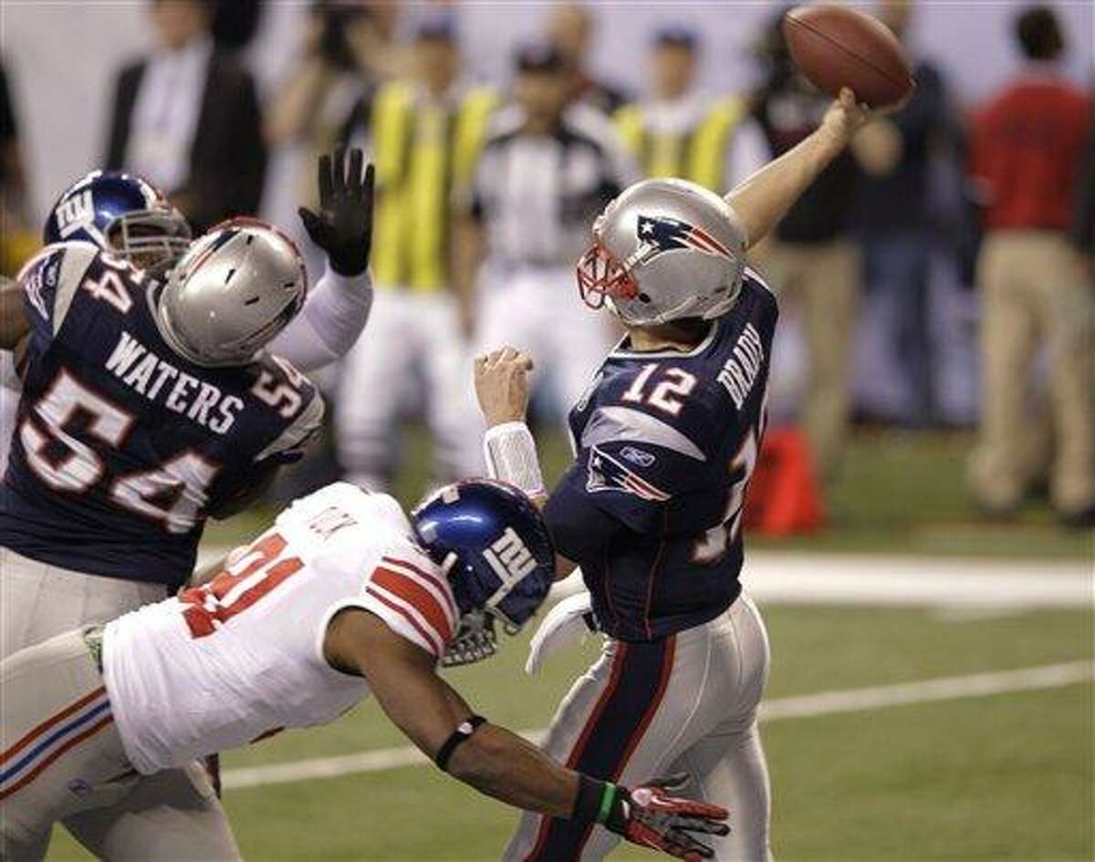 New York Giants defensive end Justin Tuck sacks New England Patriots quarterback Tom Brady for a safety during the first half of NFL Super Bowl XLVI football game, Sunday, Feb. 5, 2012, in Indianapolis. (AP Photo/Michael Conroy)