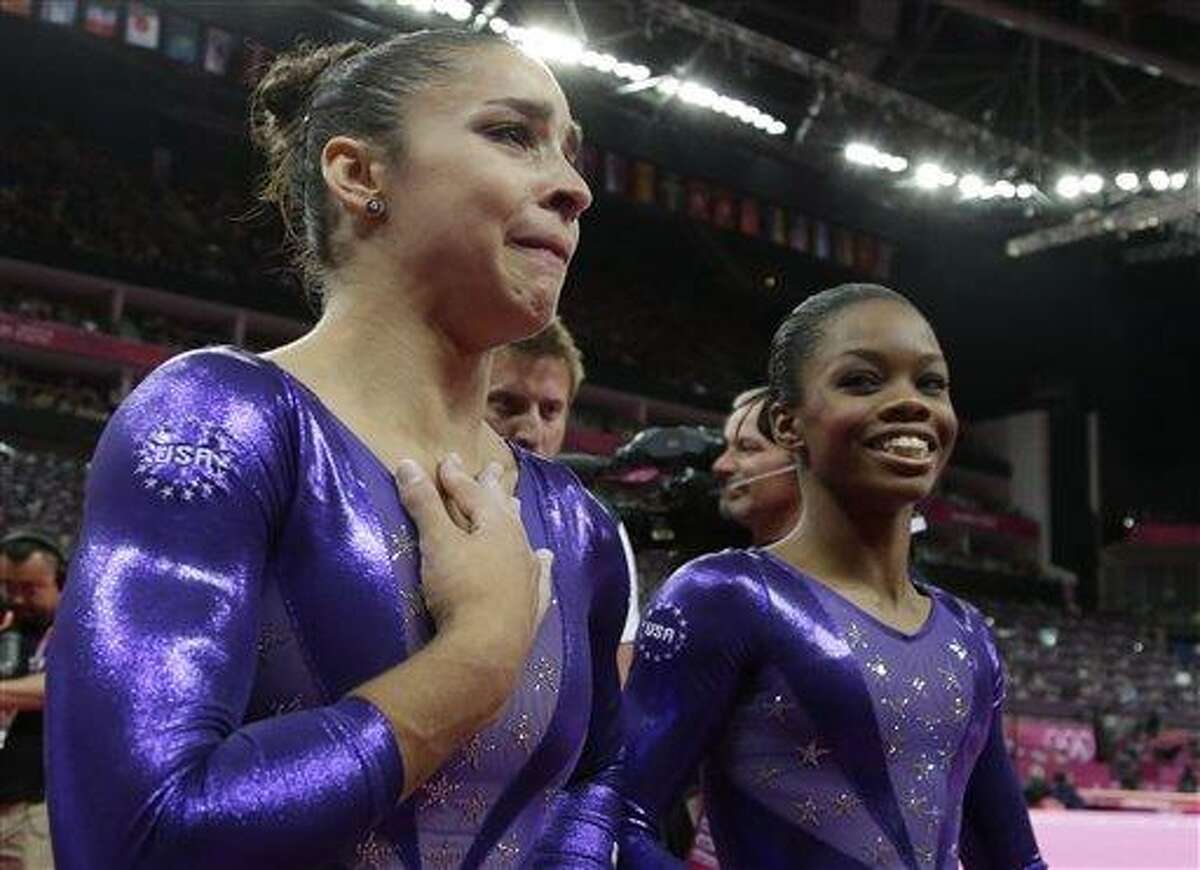 U.S. gymnast Alexandra Raisman, left, reacts after qualifying for the women's all-around final along with teammate Gabrielle Douglas during the Artistic Gymnastics women's qualification at the 2012 Summer Olympics Sunday in London. Associated Press