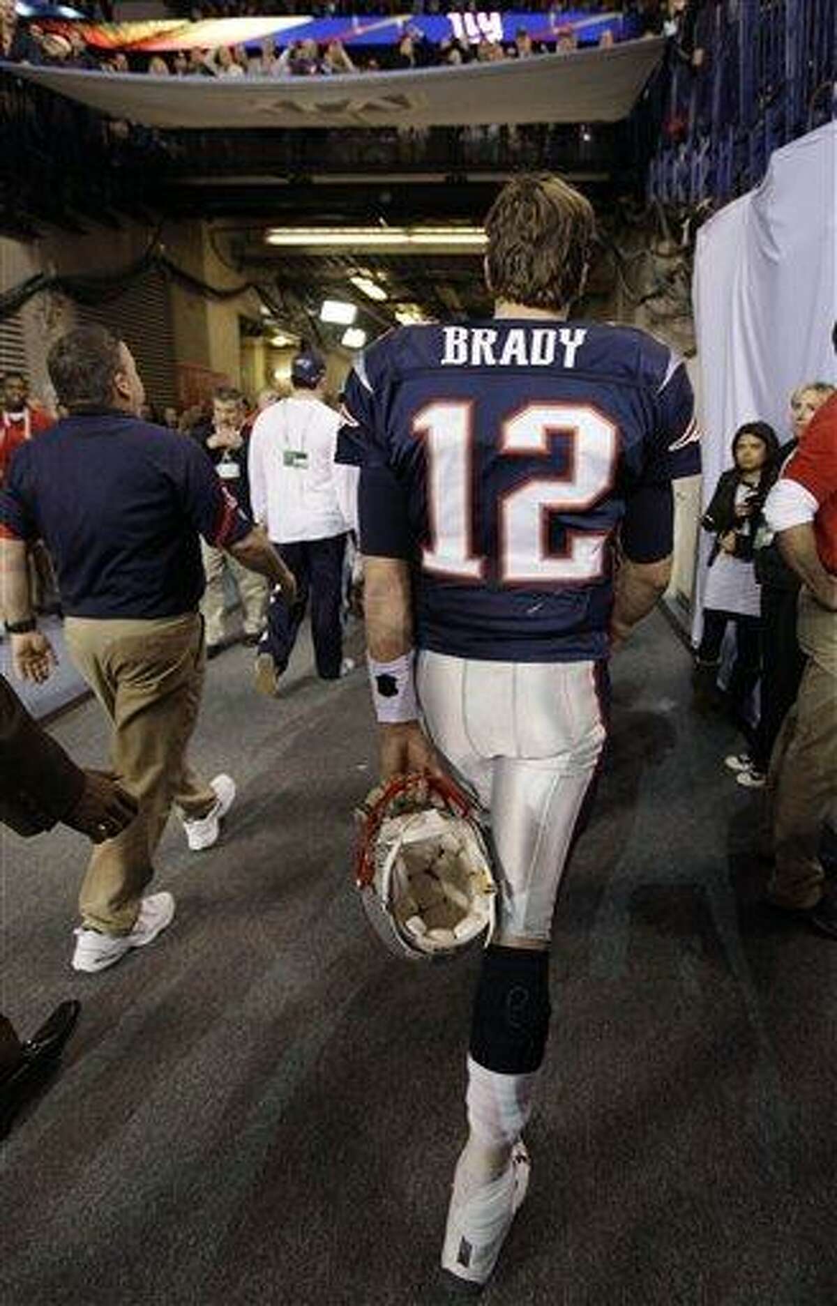 New England Patriots quarterback Tom Brady walks off the field after the Patriots lost to the New York Giants 21-17 in the NFL Super Bowl XLVI football game, Sunday, Feb. 5, 2012, in Indianapolis. (AP Photo/Paul Sancya)