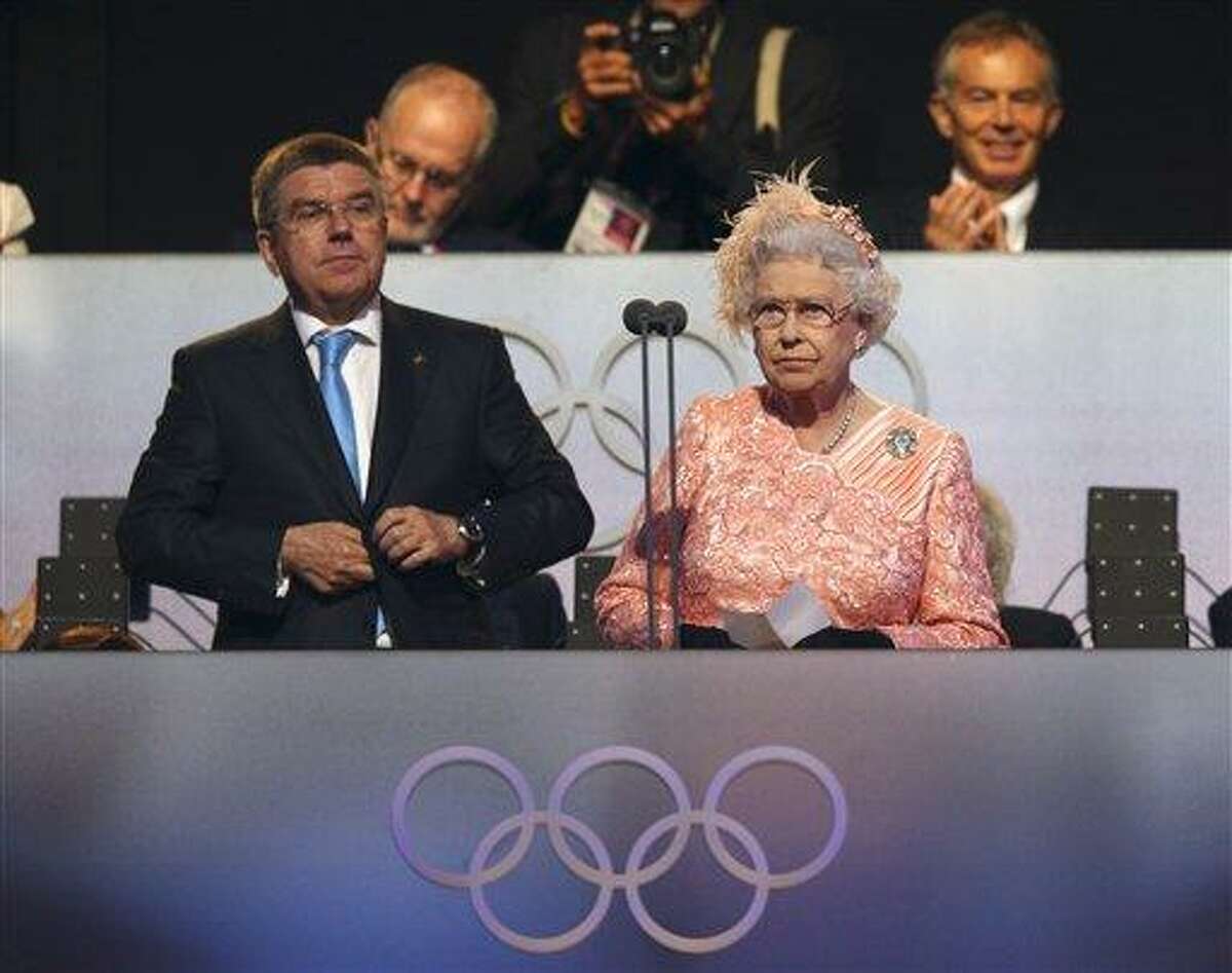 Britain's Queen Elizabeth II, right, declares the games open alongside International Olympic Committee Vice President Thomas Bach during the Opening Ceremony at the 2012 Summer Olympics, Saturday, July 28, 2012, in London. (AP Photo/Cameron Spencer, Pool)