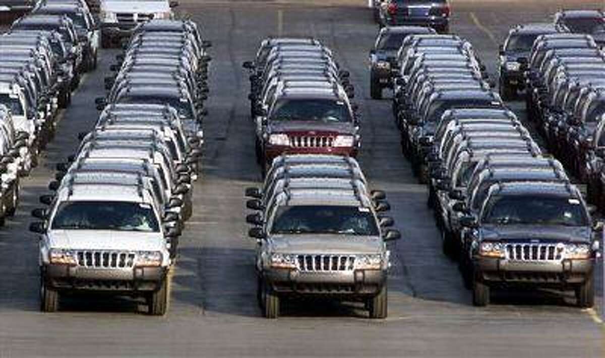 FILE - In this file photo taken Fed. 2, 2001, rows of 2001 Jeep Grand Cherokees are lined up outside the Jefferson North Assembly Plant in Detroit. Chrysler is refusing a request by U.S. safety regulators to recall about 2.7 million vehicles to fix fuel tanks that could leak and cause fires in rear-end collisions.The company says it's been asked by the government to recall Jeep Grand Cherokees from 1993 through 2004 and Jeep Libertys from 2002 through 2007. But Chrysler says in a statement that the SUVs are safe and not defective. (AP Photo/Carlos Osorio, File)