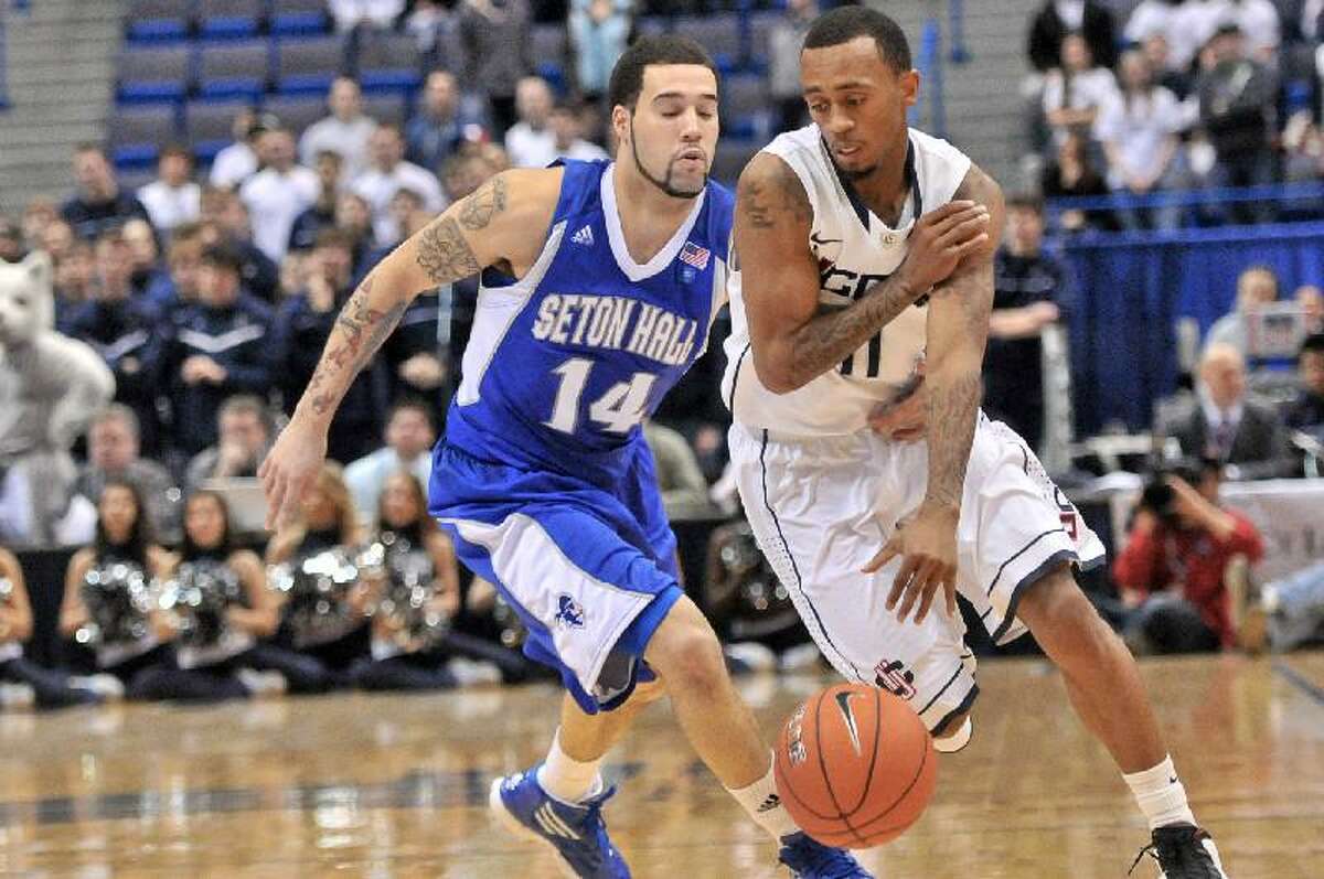 ASSOCIATED PRESS Connecticut's Ryan Boatright gets around Seton Hall's Freddie Wilson during the second of Saturday afternoon's game at the XL Center in Hartford. Wilson has found some playing time as a true freshman with the Pirates.
