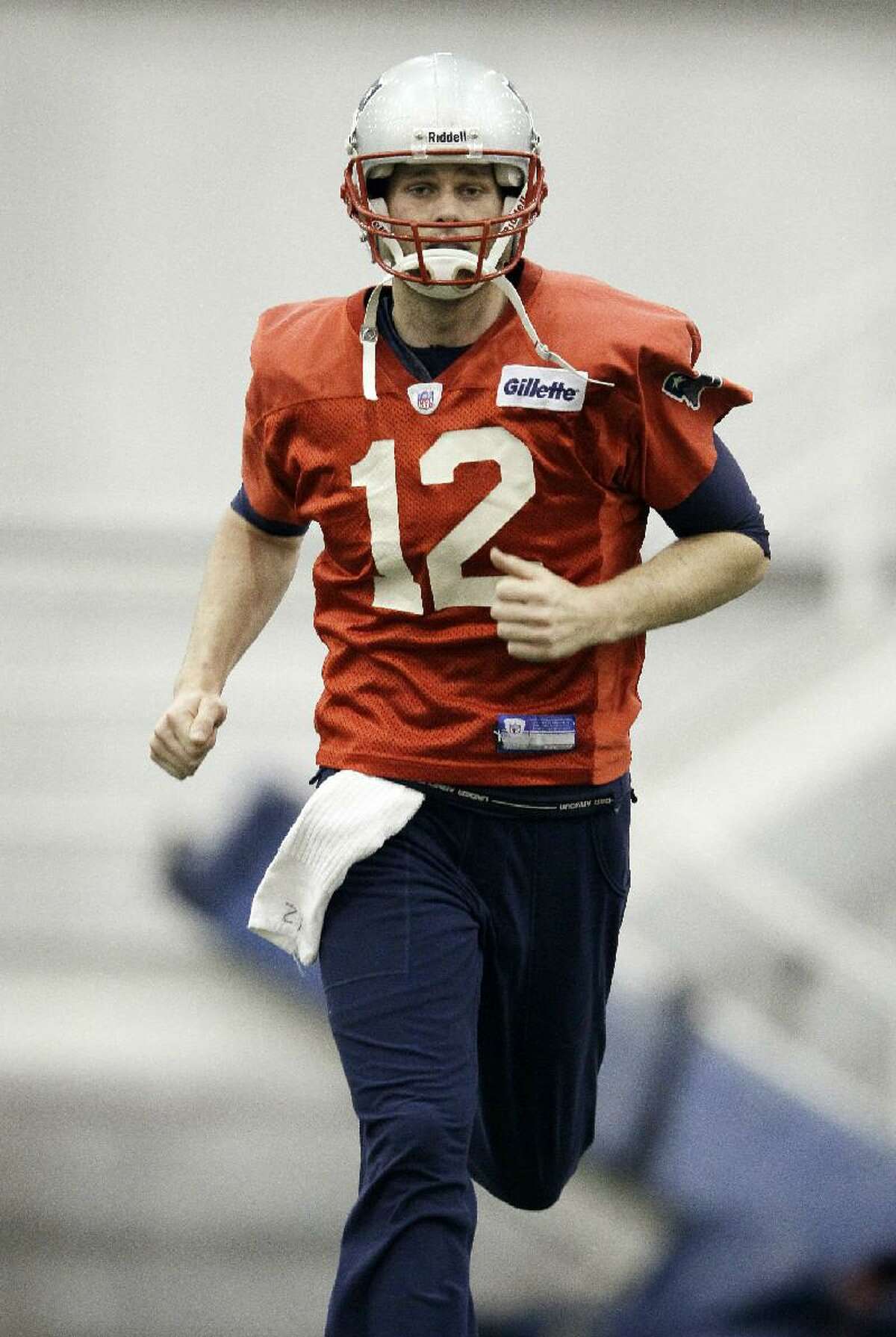 ASSOCIATED PRESS New England Patriots quarterback Tom Brady (12) runs during practice on Wednesday in Indianapolis. The Patriots are scheduled to face the New York Giants in Super Bowl XLVI Sunday.