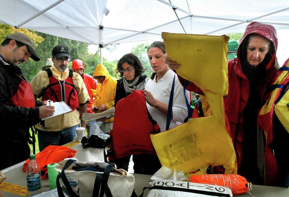 CROMWELL-DEP Commissioner Dan Esty leads an afternoon of exploring the resourses of the Connecticut and Mattabesset Rivers. Here, people are picking up their life preservers. Melanie Stengel/New Haven Register