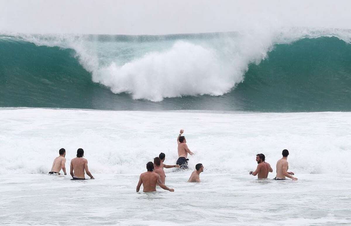 Italy players relax in the breakers of the Atlantic ocean at the soccer Confederations Cup in Rio de Janeiro, Brazil, Monday, June 17, 2013. (AP Photo/Antonio Calanni)