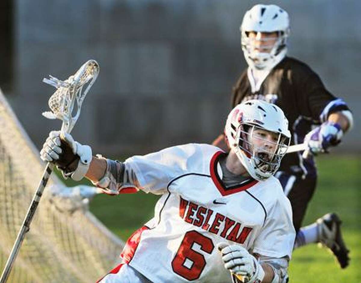 @CAvaloneMP 3.28.12 Wesleyan freshman attack David Murphy battles Amherst junior midfielder John Sinnigen Wednesday afternoon. Wesleyan defeated Amherst 6-3 at Jackson Field. To buy a print of this photo and more, visit the photo gallery at www.middletownpress.com