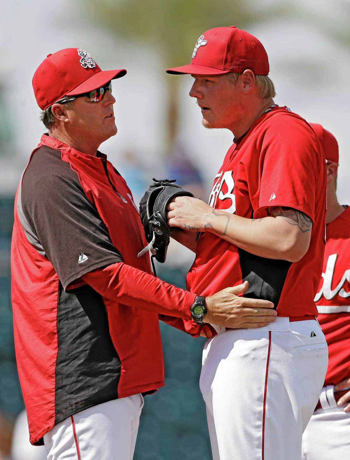 In this March 28 file photo, Cincinnati Reds pitching coach Bryan Price, left, talks to starter Mat Latos in the third inning of a spring training game against the Kansas City Royals in Goodyear, Ariz. The Reds have chosen Price to replace Dusty Baker as their next manager.