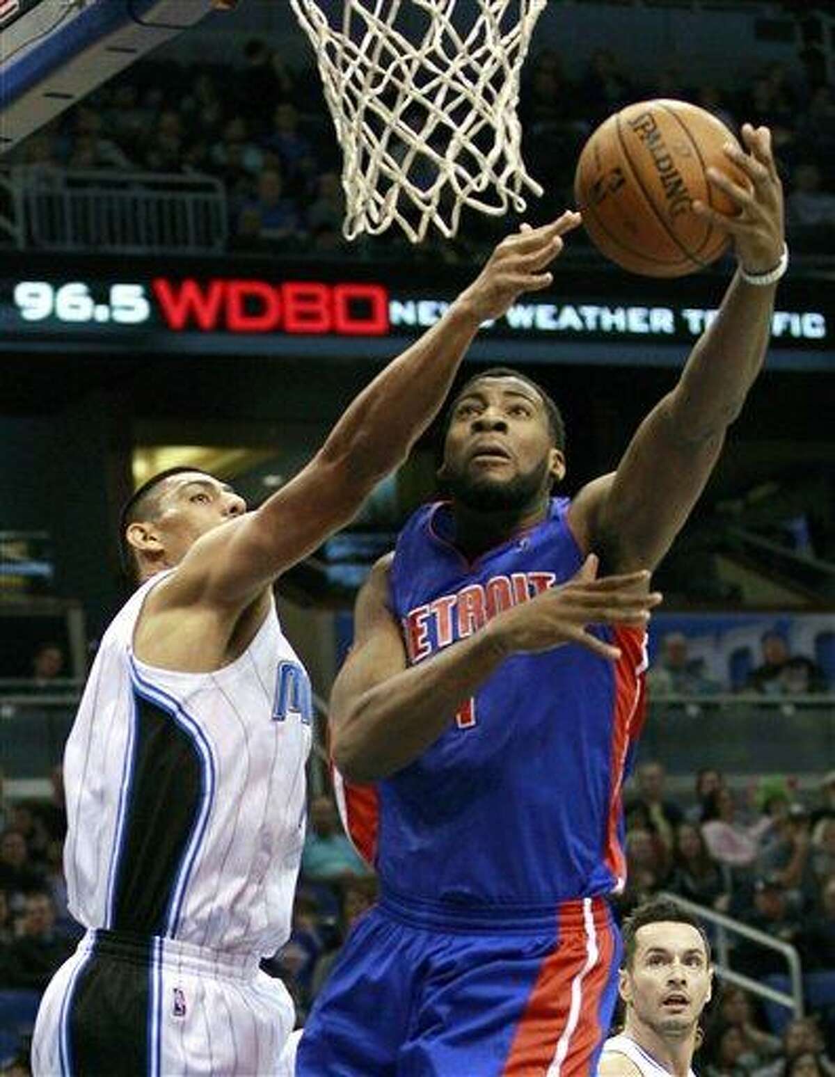 Detroit Pistons' Andre Drummond, right, makes a shot despite defensive effort by Orlando Magic's Gustavo Ayon, left, of Mexico, during the first half of an NBA basketball game, Wednesday, Nov. 21, 2012, in Orlando, Fla. (AP Photo/John Raoux)
