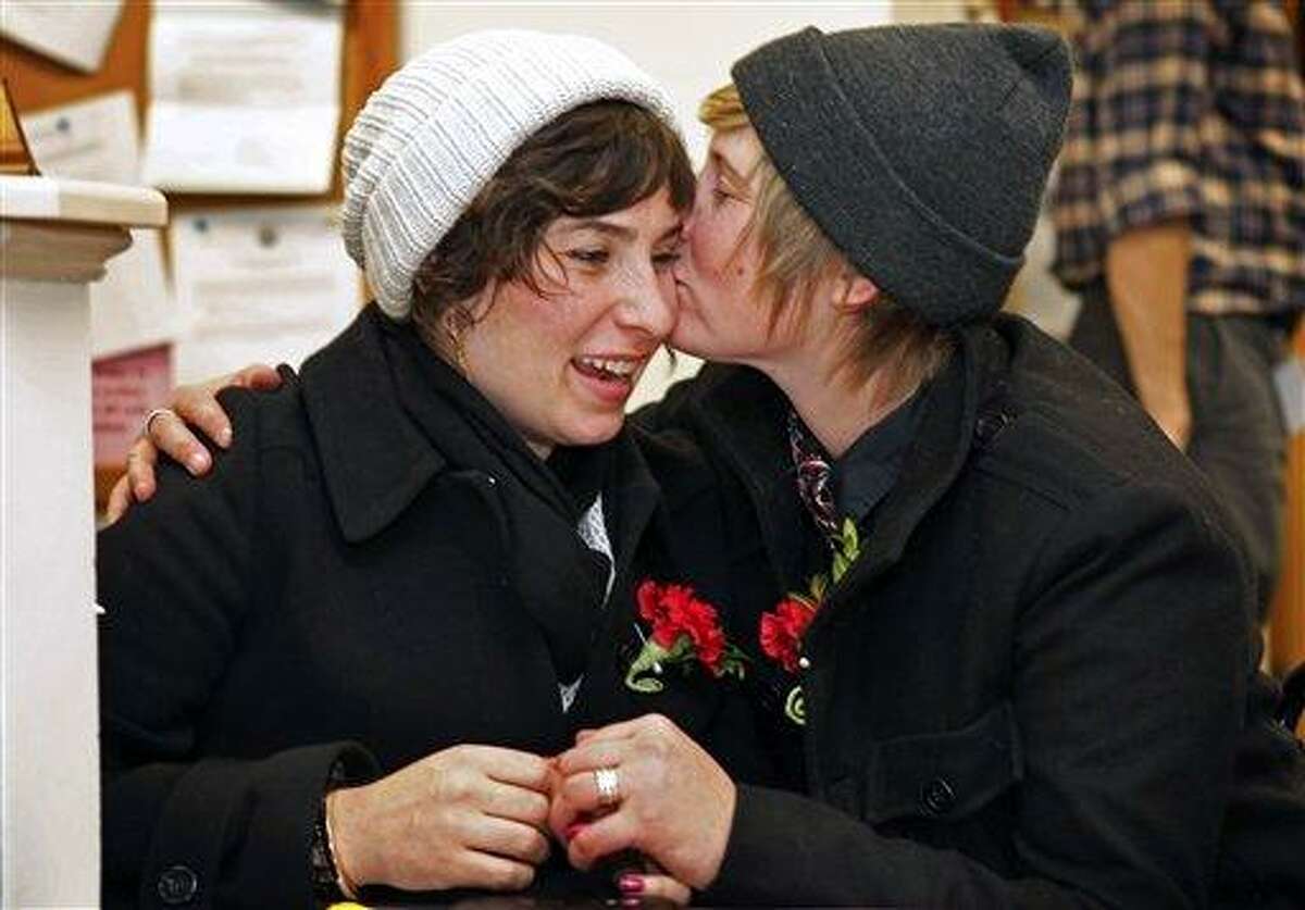 Katy Jayne, left, gets a kiss from Lauren Snead after they obtained their marriage license, early Saturday, Dec. 29, 2012, at City Hall in Portland, Maine. Same-sex couples in Maine are now legally permitted to marry under a new law that went into effect at 12:01 a.m. on Saturday. AP Photo/Robert F. Bukaty