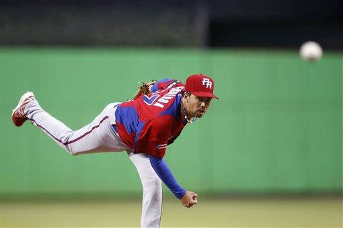 Puerto Rico's Nelson Figueroa delivers a pitch during the first inning of the second round elimination game at the World Baseball Classic against the United States, Friday, March 15, 2013 in Miami. (AP Photo/Andrew Innerarity, Pool)