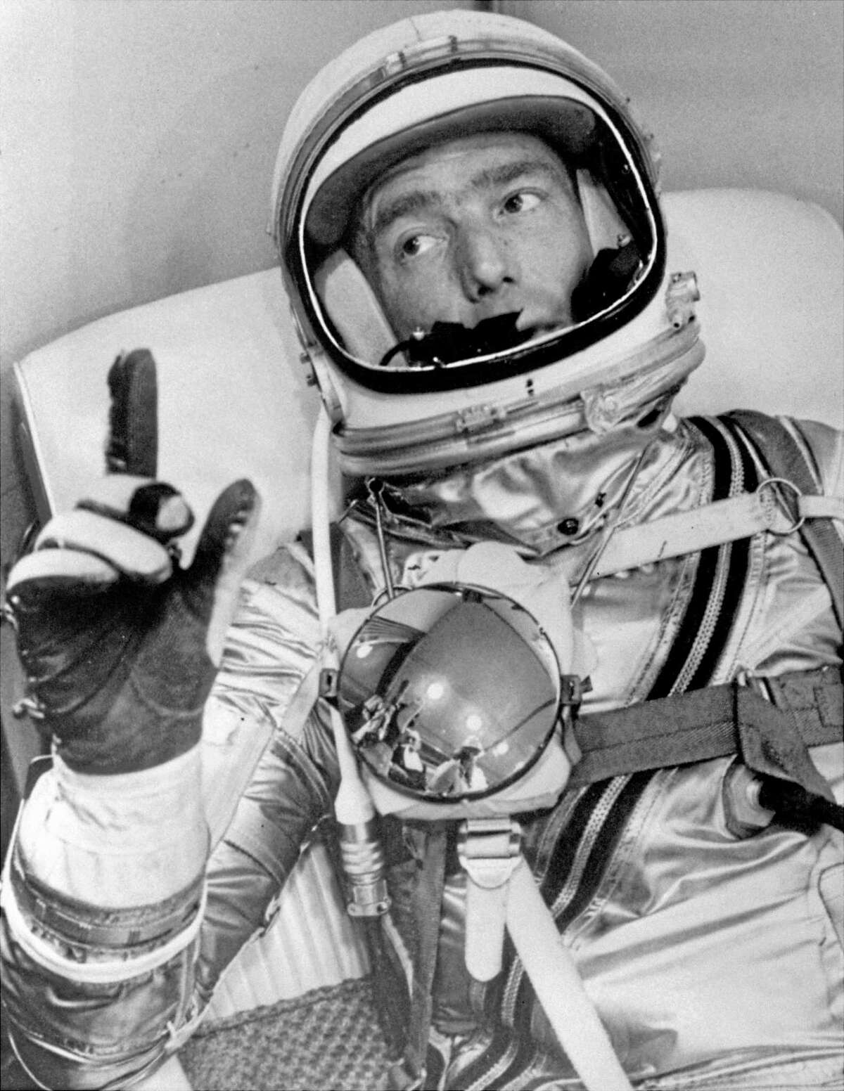 FILE - In this May 24, 1962 file photo provided by NASA, astronaut Scott Carpenter gestures with one hand after donning his space suit in Hangar S prior to being shot into orbit at Cape Canaveral, Fla. Carpenter, the second American to orbit the Earth and first person to explore both the heights of space and depths of the ocean, died Thursday, Oct. 10, 2013 after a stroke. He was 88. (AP photo/NASA, File)
