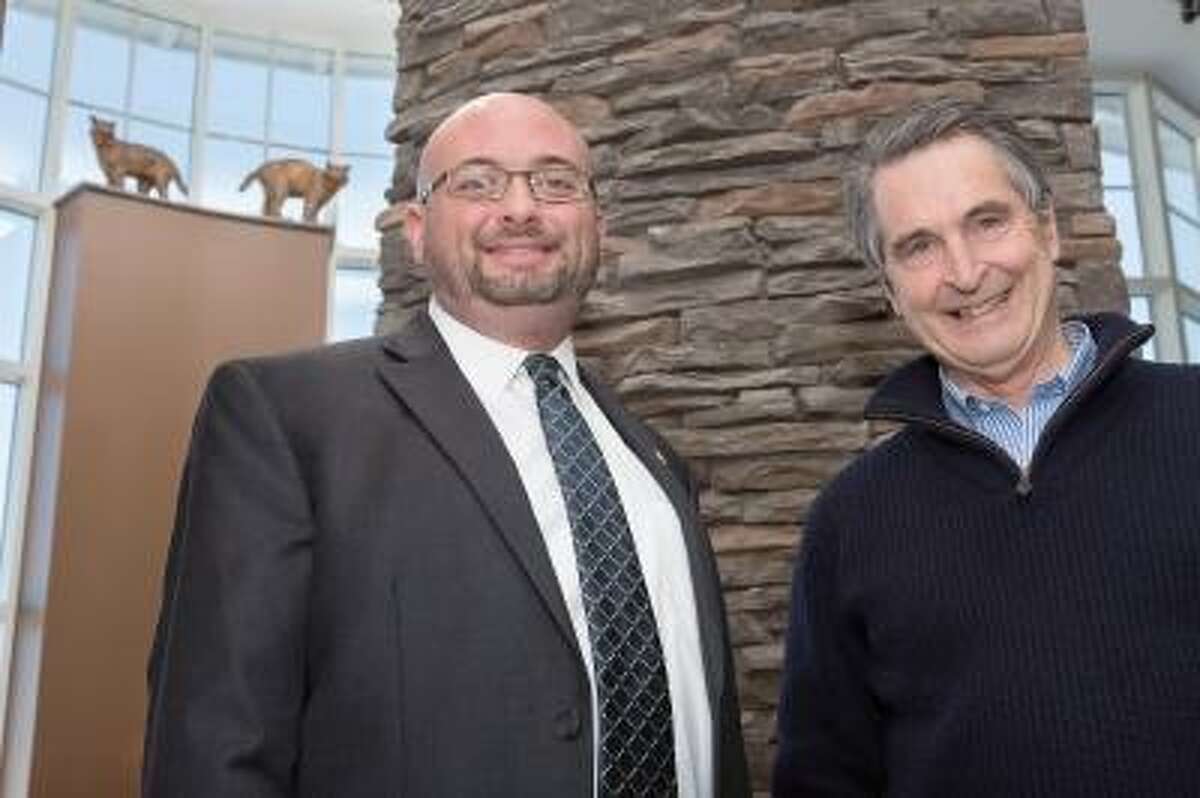 Daniel Brown (left), director of the Carl Hansen Student Center, with Jefferson Riley of Centerbrook Architects. Centerbrook donated a series of Bobcat statuettes that now overlook the newly renovated Carl Hansen Student Center on Quinnipiac University's Mount Carmel Campus. February 21, 2013.