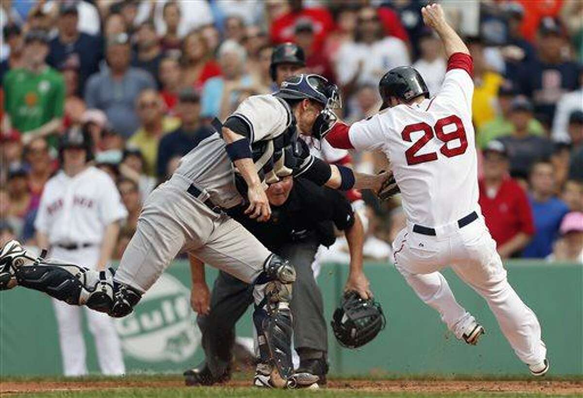 New York Yankees' Chris Stewart, left, tags out Boston Red Sox's Daniel Nava in the first inning of a baseball game in Boston, Saturday, July 20, 2013. (AP Photo/Michael Dwyer)