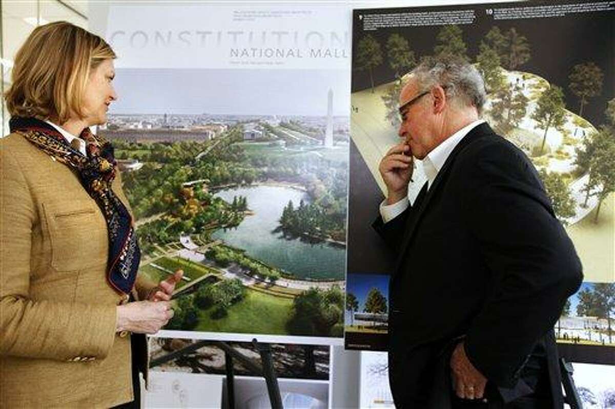 Caroline Cunningham, President of the Trust for the National Mall, left, and Donald Stastny, an architect advising the trust, look at two of several proposed designs April 5 for overused and neglected areas of the National Mall in Washington. Associated Press