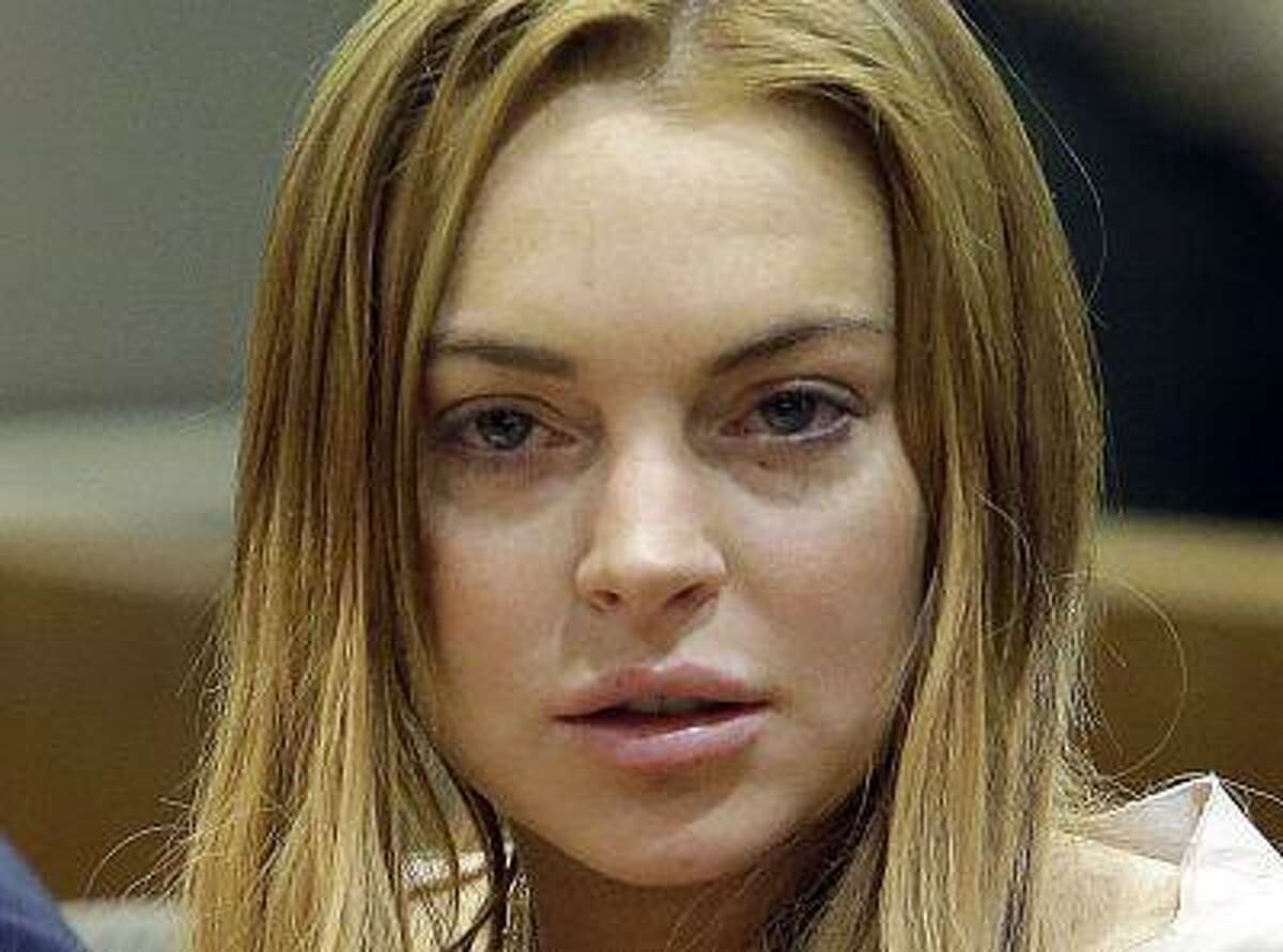 Actress Lindsay Lohan sits at a hearing in Los Angeles Superior Court in Los Angeles, California March 18, 2013. The troubled actress was ordered to spend 90 days in a locked rehabilitation facility and undertake 30 days community labor as part of a plea bargain with prosecutors over charges arising from a June 2012 car crash. REUTERS/Reed Saxon/Pool (UNITED STATES - Tags: ENTERTAINMENT CRIME LAW)