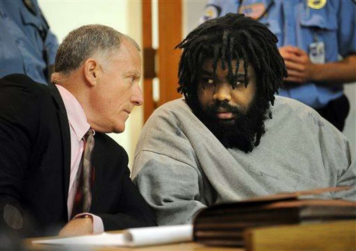 Defendant Tyree Lincoln Smith, right, makes eye contact with his attorney, public defender Joseph Bruckmann, after a three-judge panel found him not guilty by reason of insanity in the death of a homeless man he admitted to killing and partially eating, Tuesday, July 9, 2013 in state Superior Court in Bridgeport, Conn. (AP Photo/The Connecticut Post, Brian A. Pounds, Pool)