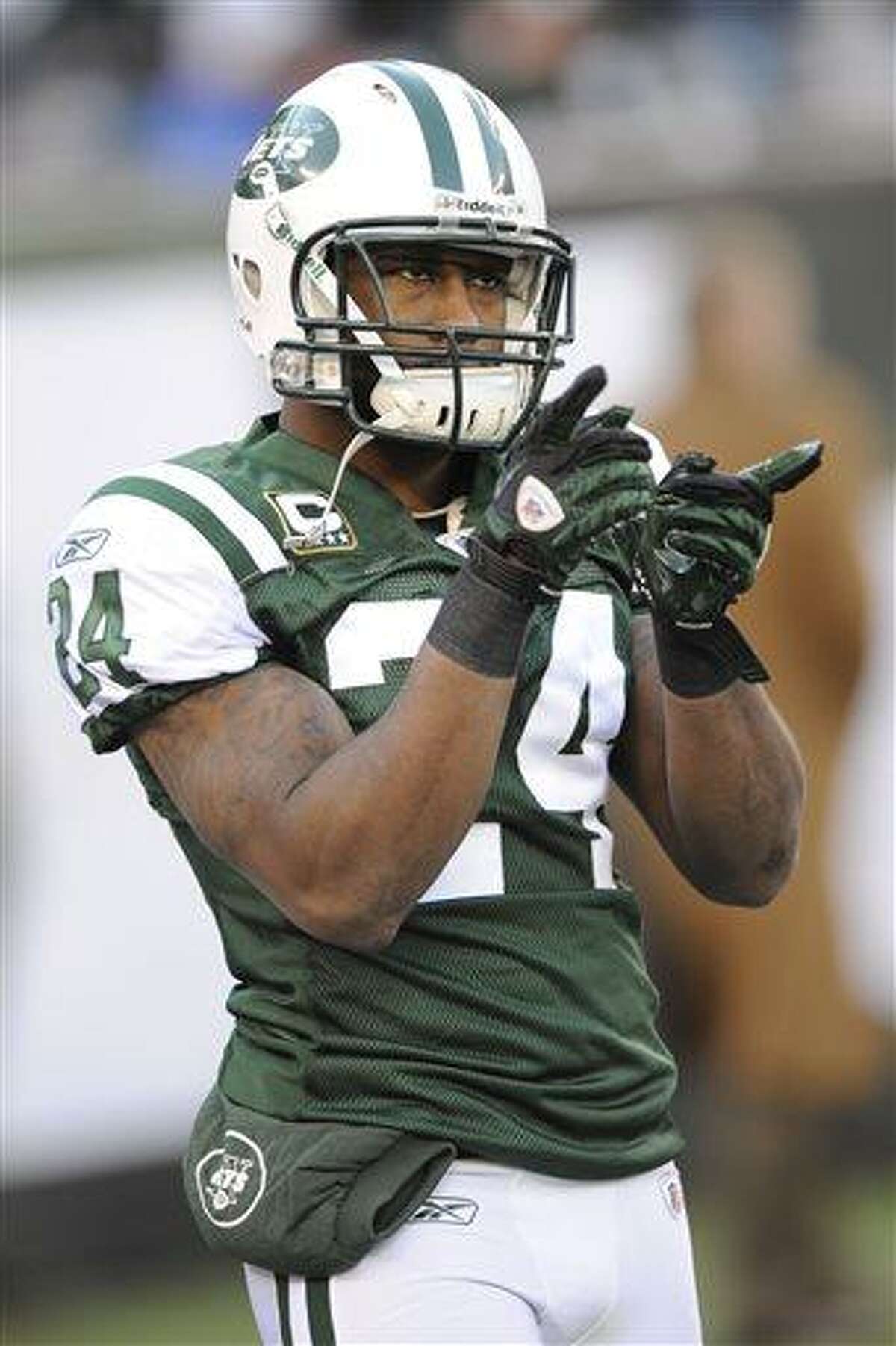 File-This Dec. 24, 2011 file photo shows New York Jets' Darrelle Revis pointing before an NFL football game between the New York Giants and the New York Jets in East Rutherford, N.J. The Jets have traded Revis to the Buccaneers for this year's No. 13 overall draft pick and another selection next year. (AP Photo/Bill Kostroun, File)