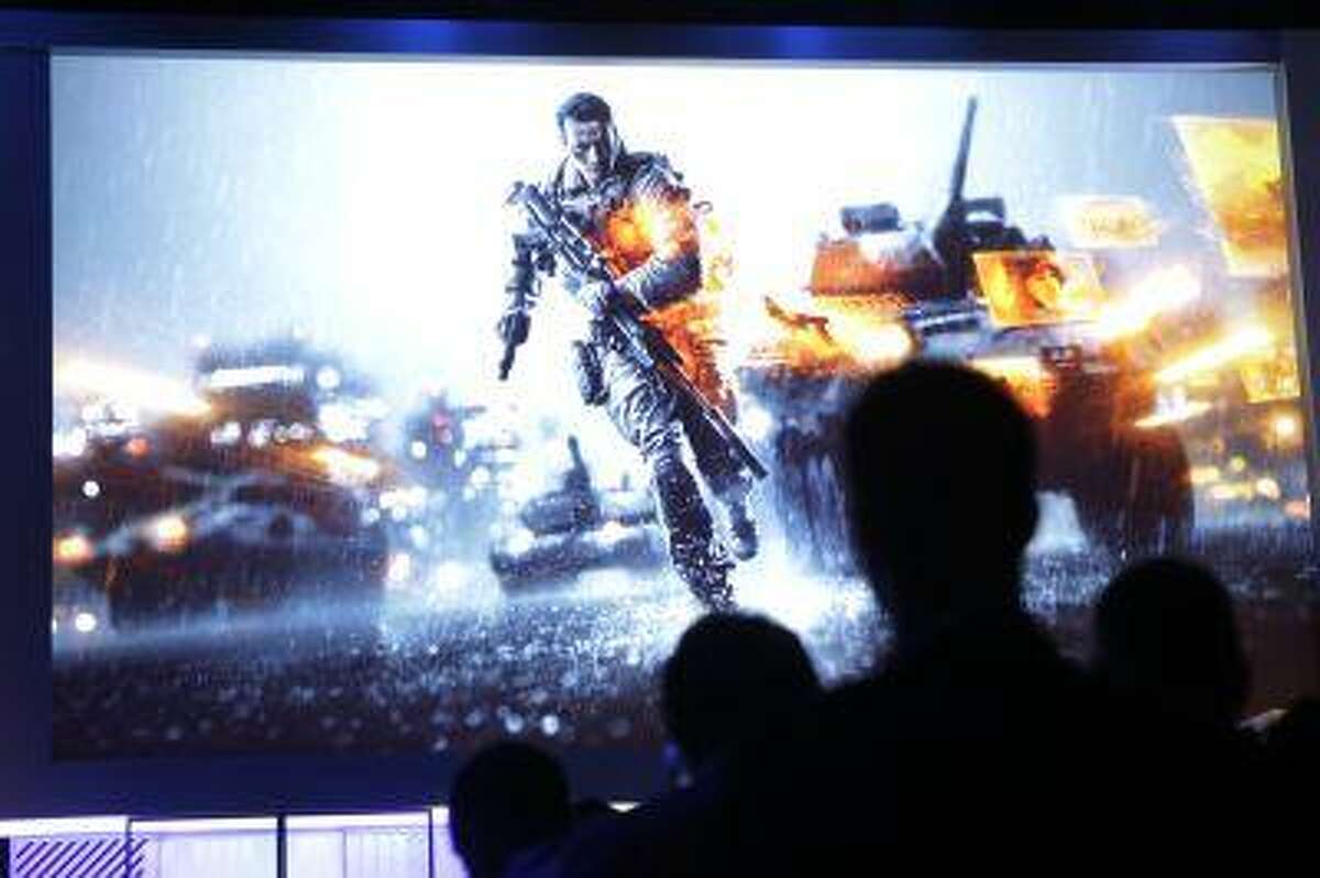 Attendees watch a presentation on video game Battlefield 4 at the Microsoft Xbox E3 media briefing in Los Angeles, Monday, June 10, 2013. Microsoft focused on how cloud computing will make games for its next-generation Xbox One console more immersive during its Monday presentation at the Electronic Entertainment Expo. (AP Photo/Jae C. Hong)