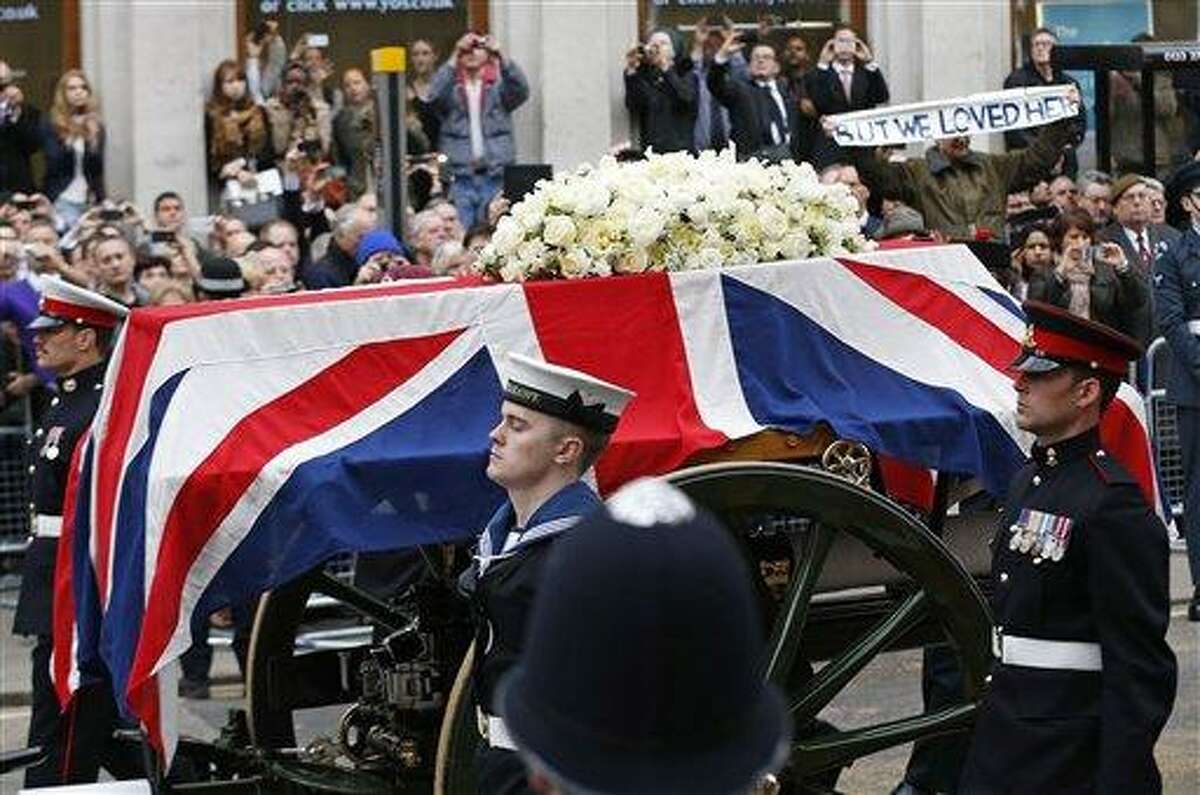 A Union flag draped coffin bearing the body of former British Prime Minister Margaret Thatcher is carried on a gun carriage drawn by the King's Troop Royal Artillery during her ceremonial funeral procession in London, Wednesday, April 17, 2013. The Iron Lady is being laid to rest - yet even in death, she remains a divisive figure. World leaders and dignitaries from 170 countries are to attend the funeral of former British Prime Minister Margaret Thatcher on Wednesday, an elaborate affair with full military honors that will culminate with a service at St. Paul's Cathedral in London. (AP Photo/Matt Dunham, Pool)