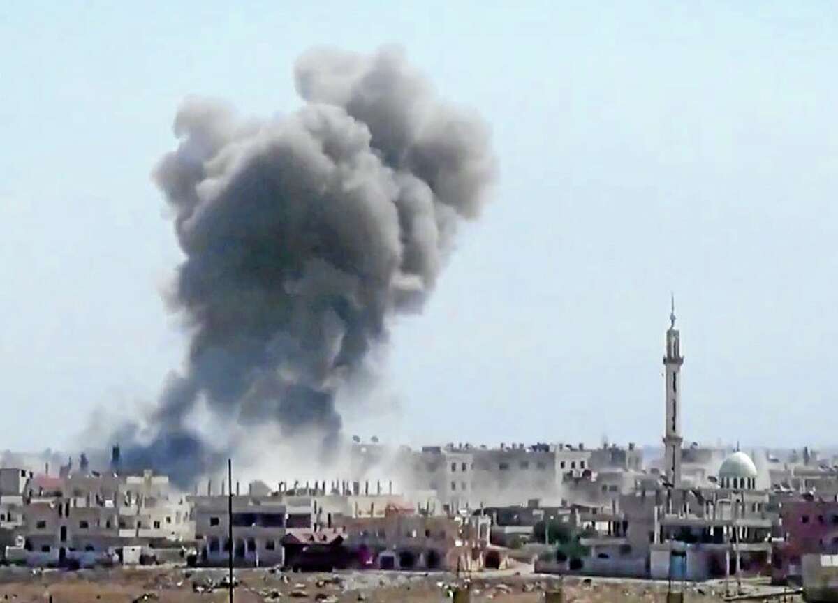 In this Tuesday, Aug. 27, 2013 image taken from video obtained from the Ugarit News, which has been authenticated based on its contents and other AP reporting, smoke rises from buildings due to heavy shelling in Daraa, Syria, Wednesday, Aug. 28, 2013. (AP Photo/Ugarit News via AP video)