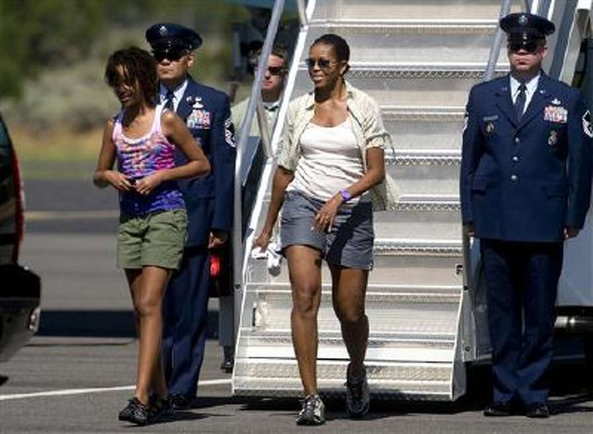Michelle Obama walks off Air Force One in 2009 wearing shorts, which she later said she regretted.