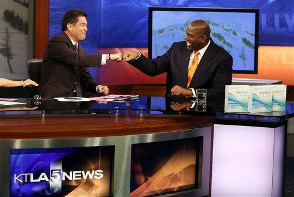 Earvin "Magic" Johnson, CEO of Magic Johnson Enterprises, right, discusses the OraQuick In-Home HIV test and the importance of knowing your HIV status with anchor Frank Buckley on the set of the KTLA Morning News Show on Monday, March 25, 2013 in Los Angeles. (Photo by Matt Sayles/Invision for OraQuick/AP Images)