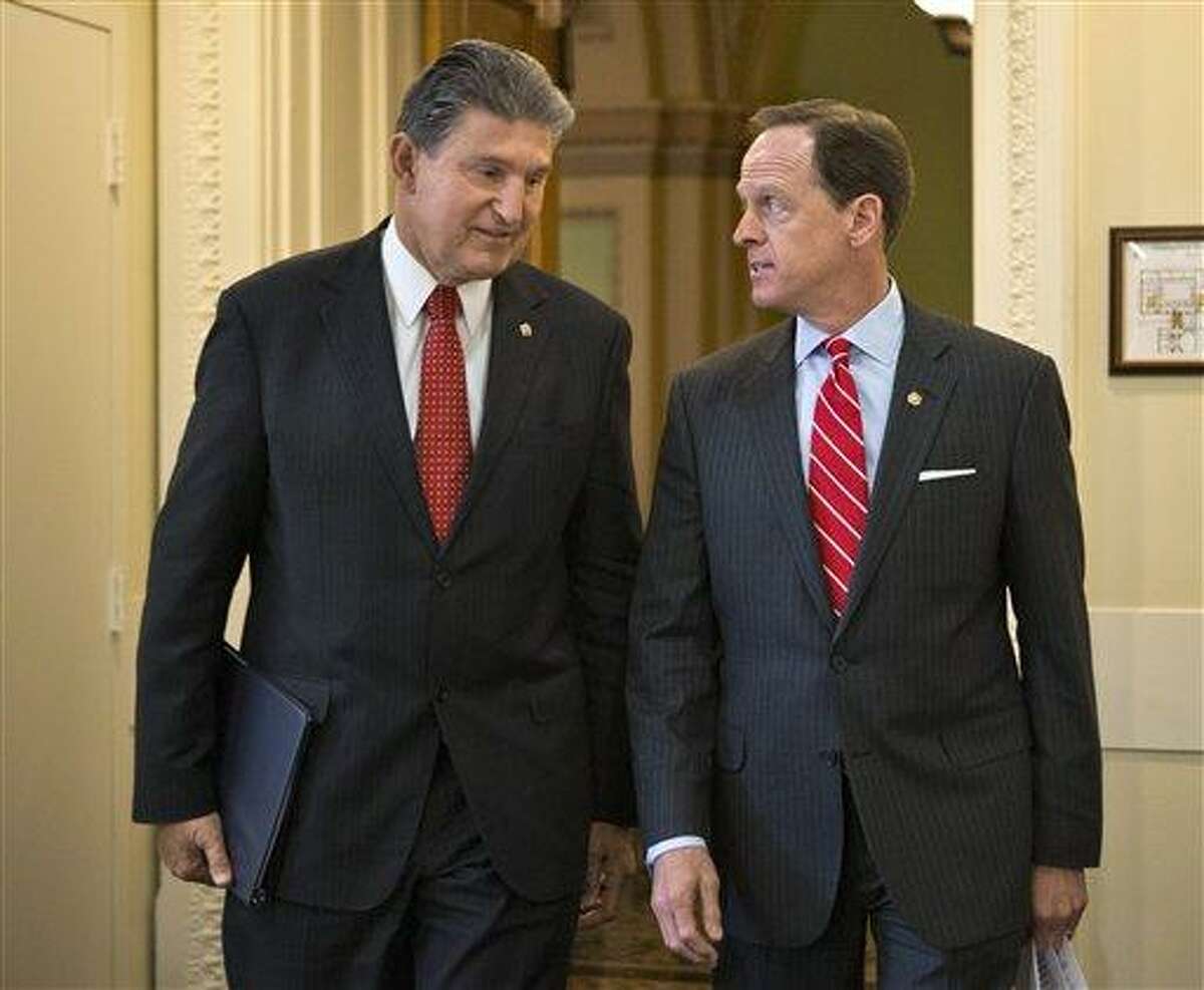 Sen. Joe Manchin, D-W.Va., left, and Sen. Patrick Toomey, R-Pa. arrive April 10 for a news conference on Capitol Hill in Washington to announce that they have reached a bipartisan deal on expanding background checks to more gun buyers. Associated Press file photo