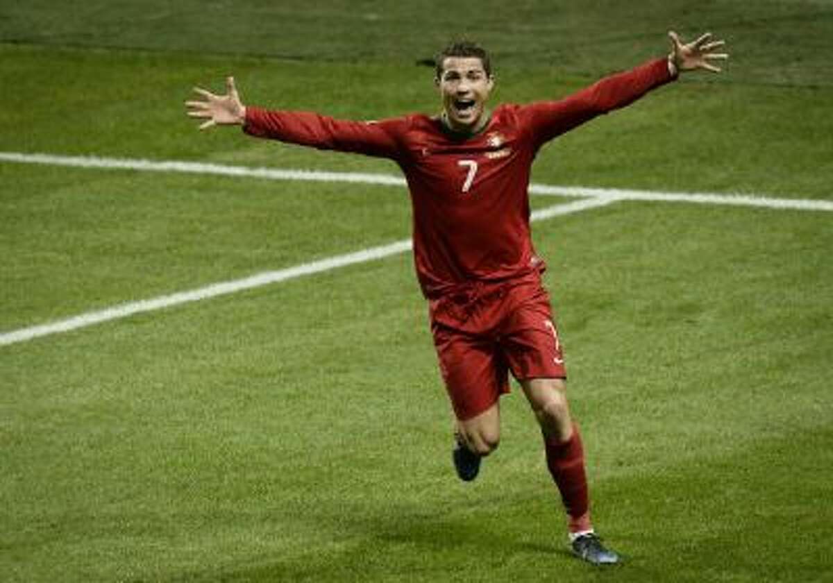Portugal's Cristiano Ronaldo celebrates after scoring the 2-3 goal during the World Cup 2014 qualifying playoff second leg soccer match between Sweden and Portugal at Friends Arena in Stockholm, Tuesday, Nov. 19, 2013.
