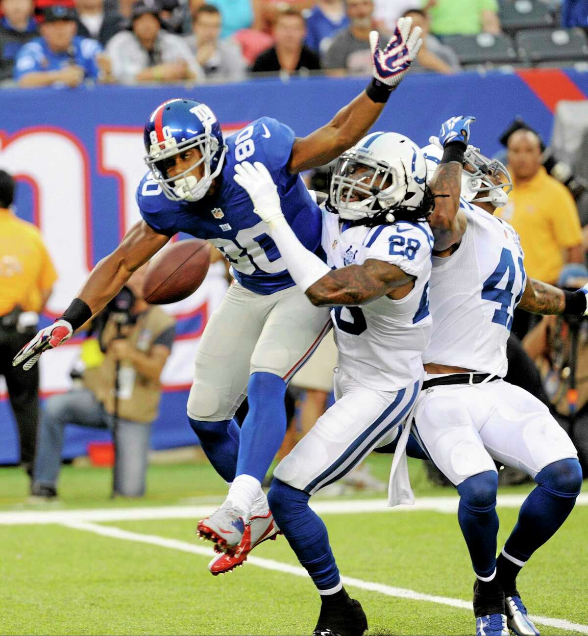 Indianapolis Colts cornerback Greg Toler (28) and Antoine Bethea (41) defend against New York Giants wide receiver Victor Cruz (80) during the first half of an Aug. 18 game in East Rutherford, N.J.