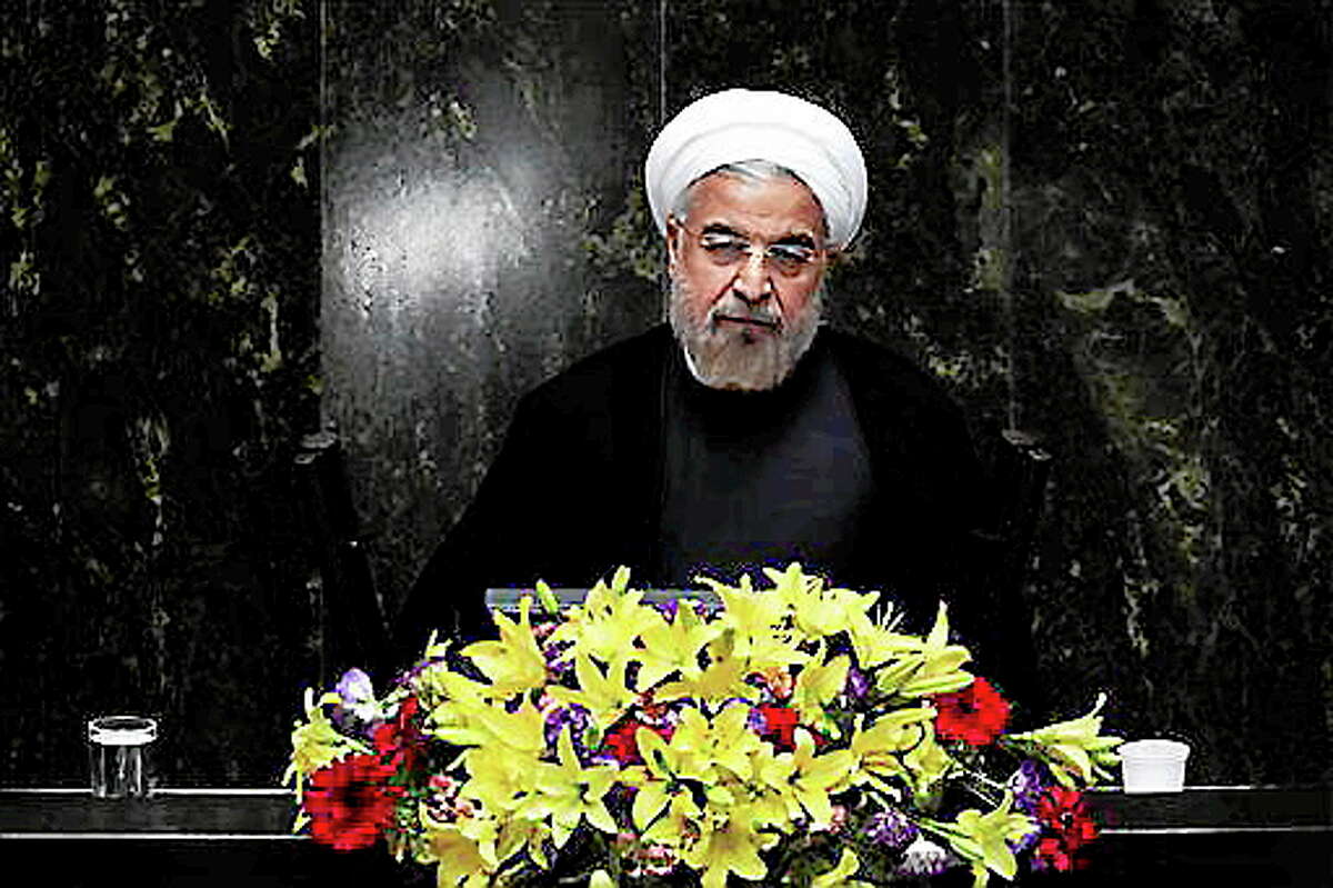 FILE - In this Aug. 15, 2013, file photo, Iranian President Hasan Rouhani speaks during the debate on the proposed Cabinet at the parliament, in Tehran, Iran. New signs are emerging that international sanctions are taking a deepening toll on Iran's economy _ putting tens of billions of dollars in oil money out of the government's reach. Yet there is no indication the distress is achieving the West's ultimate goal of forcing the Islamic Republic to halt its nuclear program. (AP Photo/Ebrahim Noroozi)