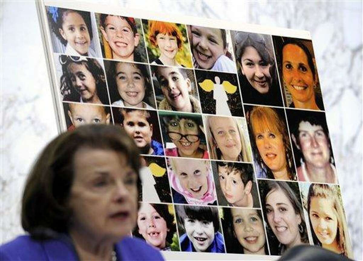 The faces of Sandy Hook Elementary School victims are seen behind Sen. Dianne Feinstein, D-Calif., as she speaks Feb. 27 about the Assault Weapons Ban of 2013 during the Senate Judiciary Committee on Capitol Hill in Washington. Congress returns Monday from a two-week spring recess with gun control and immigration high on the Senate's agenda. Senators could start debating Democratic-written gun legislation before week's end. But leaders also might decide to give negotiators more time to seek a deal on expanding background checks for firearms buyers. Associated Press file photo