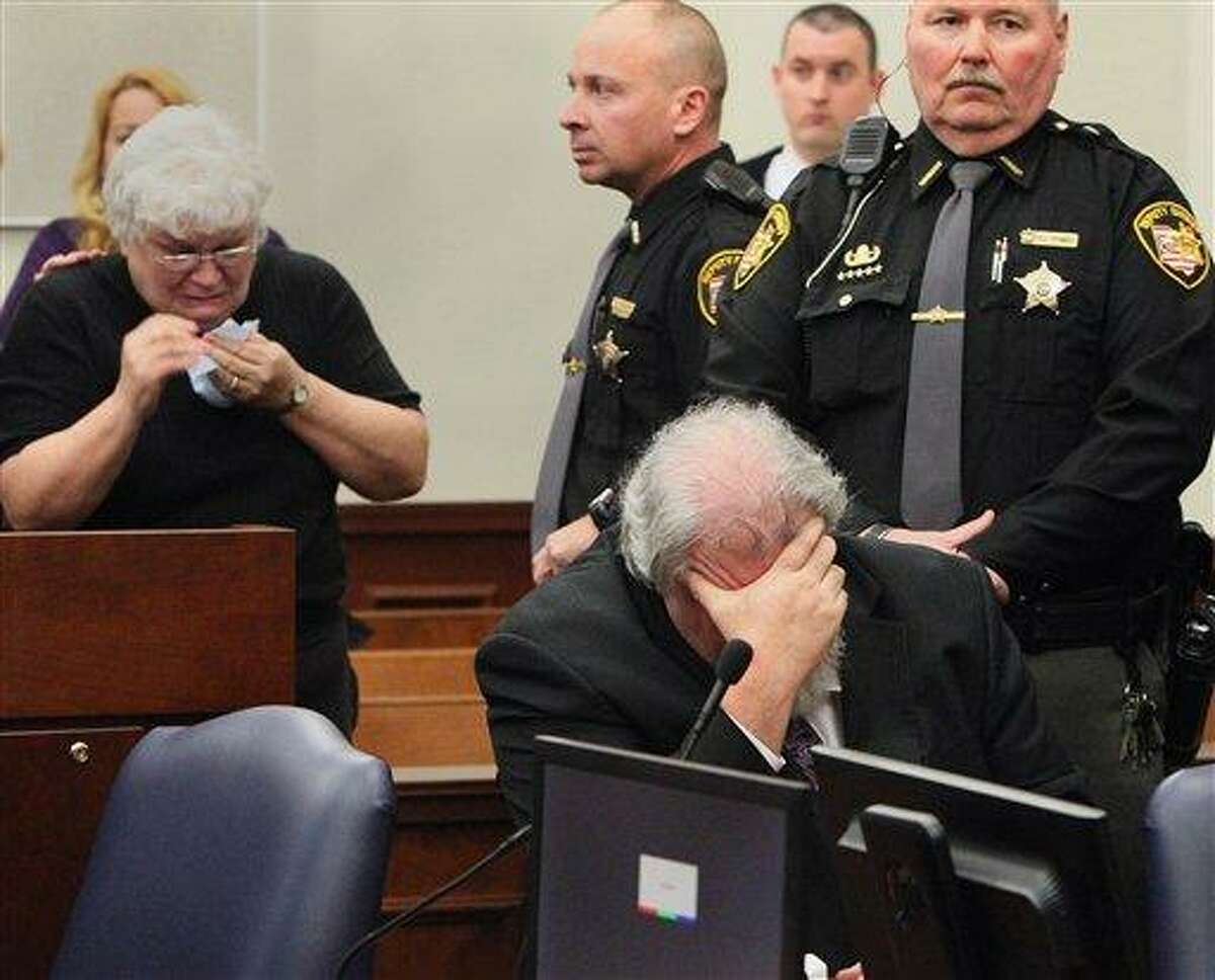 Carol Beasley, left, is in tears after the jury recommended the death penalty for her son, Richard Beasley, right, in the courtroom of Summit County Common Pleas Court Judge Lynne Callahan, Wednesday in Akron, Ohio. Beasley, a self-styled street preacher, was convicted of killing three down-and-out men lured by bogus Craigslist job offers. Associated Press