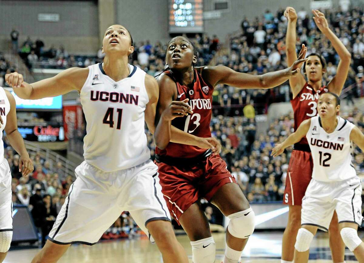 UConn’s Kiah Stokes (41) and Stanford’s Chiney Ogwumike (13) battle for a rebound as Stanford’s Tess Picknell shoots and UConn’s Saniya Chong defends during the first half of the top-ranked Huskies’ 76-57 win over No. 3 Stanford on Monday night in Storrs.