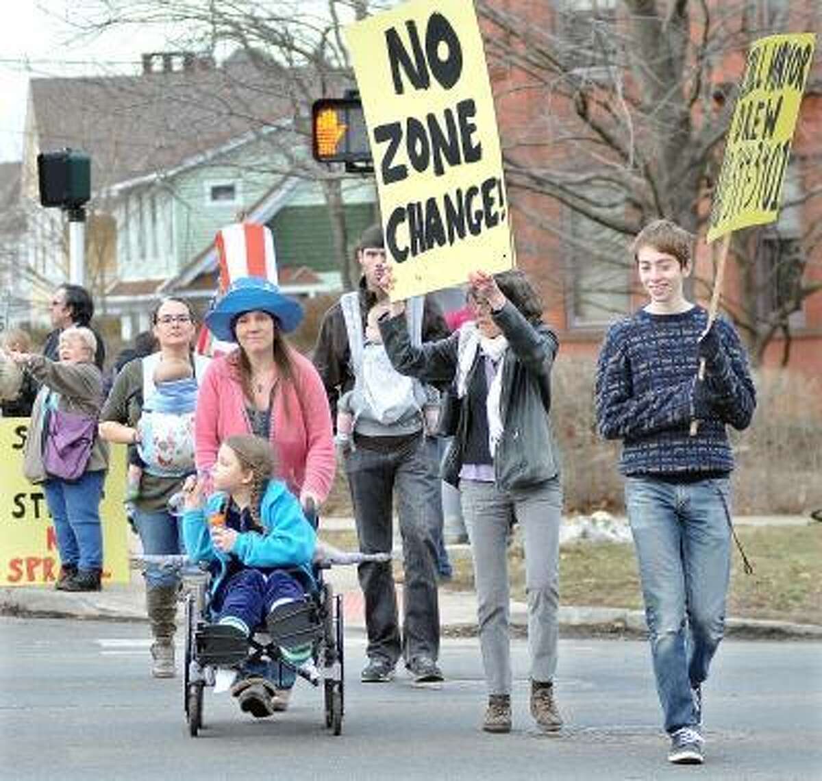 Catherine Avalone/The Middletown Press Approximately 40 Middletown residents protested carrying signs at the cross walk Monday at the intersection of Washington and High Streets in response to developer Robert Landino's proposal to change zoning for a portion of Washington Street in Middletown.