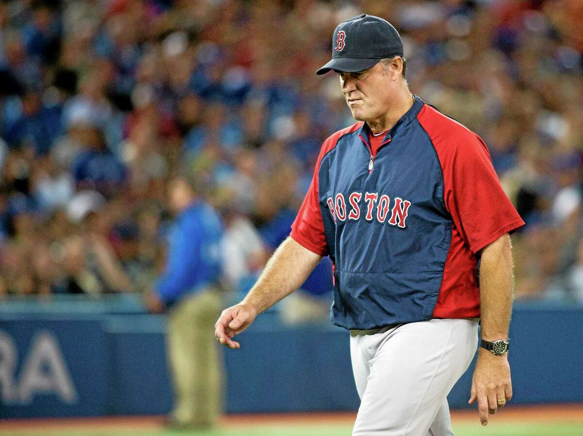 Boston Red Sox manger John Farrell walks back to the dugout while his team plays against the Toronto Blue Jays during the seventh inning of a baseball game in Toronto on Thursday, Aug. 15, 2013. (AP Photo/The Canadian Press, Nathan Denette)