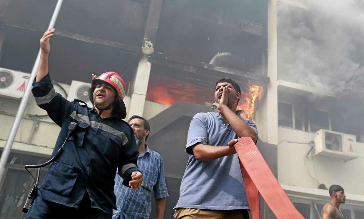 Egyptian firefighters battle flames at the Giza governorate buildings that were stormed and torched by angry supporters of Egypt's ousted president, Cairo, Egypt, Thursday, Aug. 15, 2013. Egypt faced a new phase of uncertainty on Thursday after the bloodiest day since its Arab Spring began, with hundreds of people reported killed and thousands injured as police smashed two protest camps of supporters of the deposed Islamist president. Wednesday's raids touched off day-long street violence that prompted the military-backed interim leaders to impose a state of emergency and curfew, and drew widespread condemnation from the Muslim world and the West, including the United States. (AP Photo/Hassan Ammar)