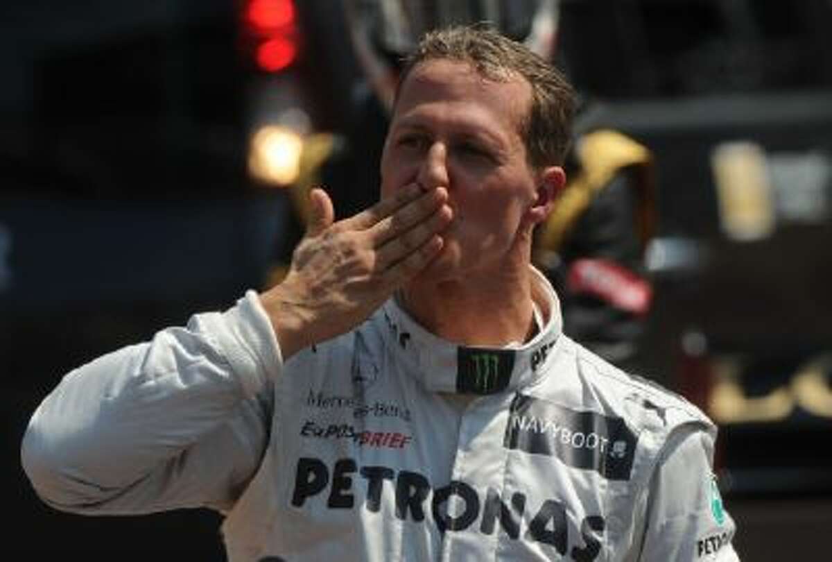 German driver Michael Schumacher blows a kiss in the parc ferme after the qualifying session at the Circuit de Monaco on May 26, 2012 in Monte Carlo ahead of the Monaco Formula One Grand Prix.