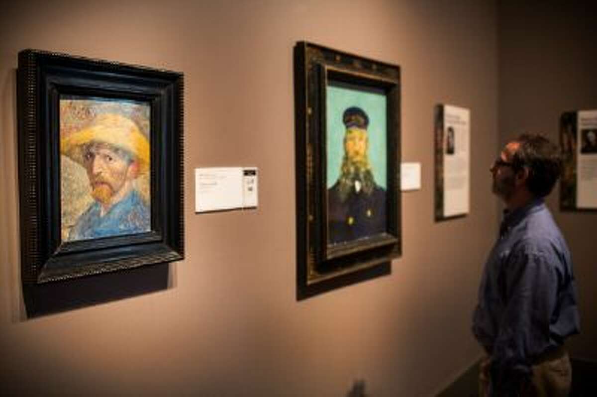 A man looks at a painting at the Detroit Institute of Arts.